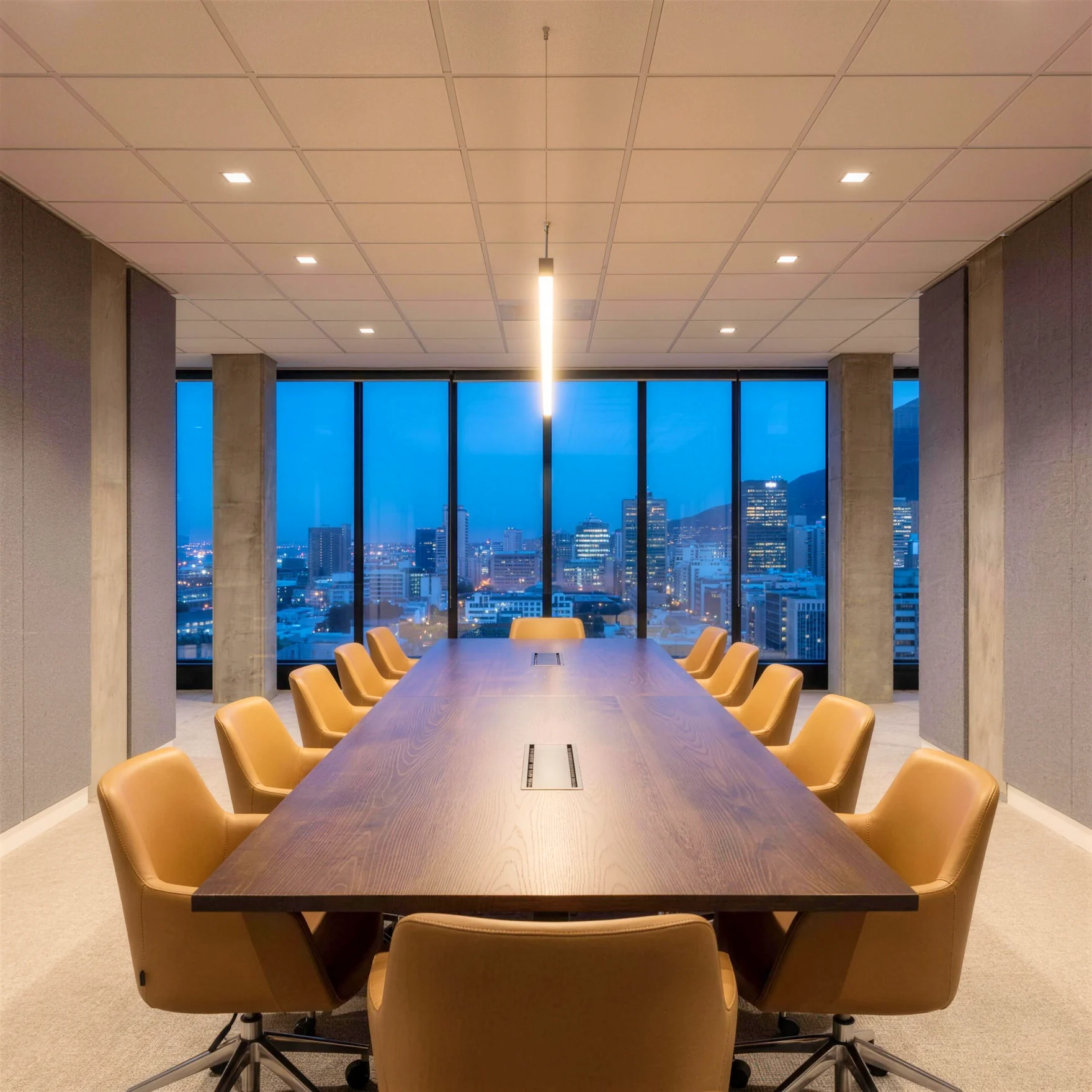 A conference room at blue hour, an oak boardroom table before a wall of glass and the lit city